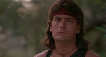 Movie still from “Hot Shots! Part Deux” (1993), directed by Jim Abrahams – A person with long hair wearing a headband; Close Up shot, Low angle