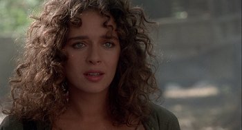 Movie still from “Hot Shots! Part Deux” (1993), directed by Jim Abrahams – A person with curly brown hair; Close Up shot, Over the shoulder angle