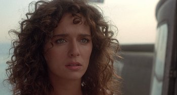 Movie still from “Hot Shots! Part Deux” (1993), directed by Jim Abrahams – A person with curly hair; Close Up shot, Over the shoulder angle