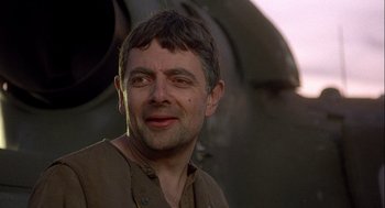 Movie still from “Hot Shots! Part Deux” (1993), directed by Jim Abrahams – A person wearing a brown shirt; Close Up shot, Low angle