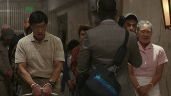 Movie still from “Hotel Artemis” (2018), directed by Drew Pearce – A group of people standing around each other in a room; Medium shot, Over the shoulder angle