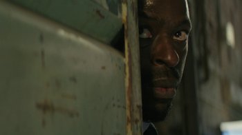 Movie still from “Hotel Artemis” (2018), directed by Drew Pearce – A person looking through a window; Close Up shot, Low angle