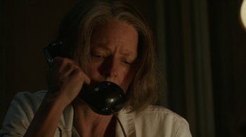 Movie still from “Hotel Artemis” (2018), directed by Drew Pearce – An older woman is talking on a phone; Close Up shot, Low angle
