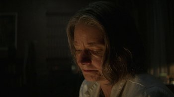 Movie still from “Hotel Artemis” (2018), directed by Drew Pearce – An older woman with long hair is looking down at her face; Close Up shot, Low angle