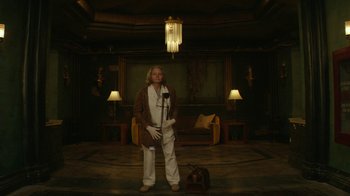 Movie still from “Hotel Artemis” (2018), directed by Drew Pearce – A man standing in a room with a microphone; Wide shot, Low angle