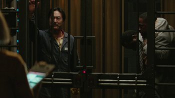 Movie still from “Hotel Artemis” (2018), directed by Drew Pearce – A man standing in front of a machine; Medium shot, Low angle