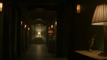 Movie still from “Hotel Artemis” (2018), directed by Drew Pearce – A dark hallway with lights on and lamps on the wall; Wide shot, High angle
