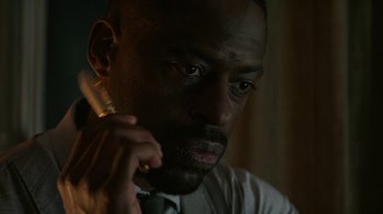 Movie still from “Hotel Artemis” (2018), directed by Drew Pearce – A person holding a cigarette in his hand; Close Up shot, Over the shoulder angle