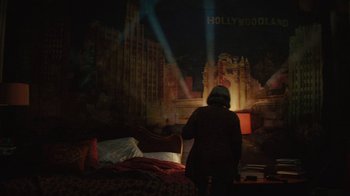 Movie still from “Hotel Artemis” (2018), directed by Drew Pearce – A woman standing in front of a bed in a room; Wide shot, High angle