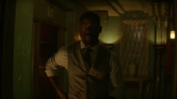Movie still from “Hotel Artemis” (2018), directed by Drew Pearce – A man in a white shirt and a tie; Medium shot, Low angle