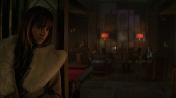 Movie still from “Hotel Artemis” (2018), directed by Drew Pearce – A woman standing in front of an open door; Medium shot, Over the shoulder angle