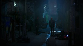 Movie still from “Hotel Artemis” (2018), directed by Drew Pearce – Two men standing in an alleyway at night; Wide shot, High angle