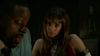 Movie still from “Hotel Artemis” (2018), directed by Drew Pearce – A woman in a red dress and a man in a black suit; Close Up shot, Over the shoulder angle