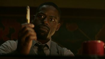 Movie still from “Hotel Artemis” (2018), directed by Drew Pearce – A man holding a cell phone up to his face; Close Up shot, Low angle