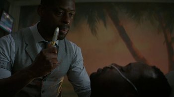 Movie still from “Hotel Artemis” (2018), directed by Drew Pearce – A man holding a banana in his hand while standing next to another man; Close Up shot, Over the shoulder angle