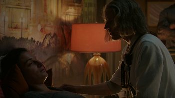Movie still from “Hotel Artemis” (2018), directed by Drew Pearce – A man with long white hair is looking at a woman with blonde hair; Medium shot, Over the shoulder angle