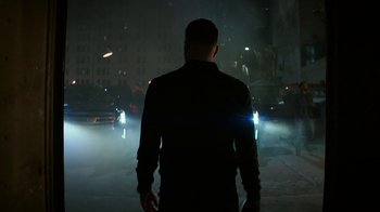 Movie still from “Hotel Artemis” (2018), directed by Drew Pearce – A man standing in the middle of a street at night; Wide shot, Low angle