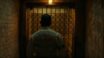 Movie still from “Hotel Artemis” (2018), directed by Drew Pearce – A man standing in front of an open door; Medium shot, Low angle