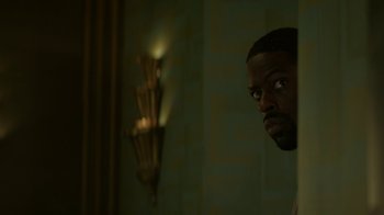 Movie still from “Hotel Artemis” (2018), directed by Drew Pearce – A person with a candle in the background; Close Up shot, Low angle