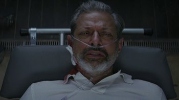 Movie still from “Hotel Artemis” (2018), directed by Drew Pearce – An older man wearing a white shirt and a white beard; Close Up shot, Overhead angle