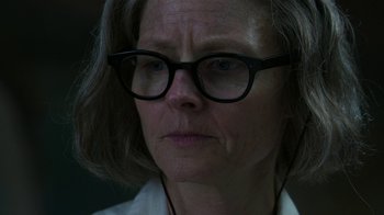 Movie still from “Hotel Artemis” (2018), directed by Drew Pearce – An older woman wearing glasses and a white shirt; Close Up shot, Low angle