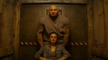 Movie still from “Hotel Artemis” (2018), directed by Drew Pearce – A man and a woman standing next to each other; Medium shot, Overhead angle