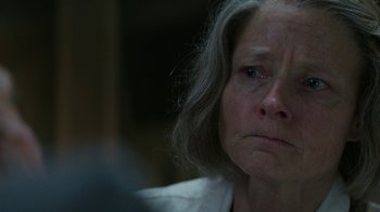 Movie still from “Hotel Artemis” (2018), directed by Drew Pearce – An older woman with long gray hair looking at the camera; Close Up shot, Over the shoulder angle