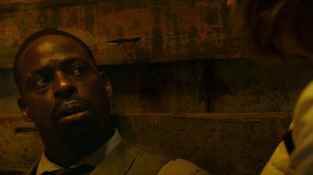 Movie still from “Hotel Artemis” (2018), directed by Drew Pearce – A person wearing a suit and tie; Close Up shot, Low angle