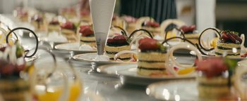 Movie still from “Hotel Mumbai” (2018), directed by Anthony Maras – A bunch of food is on a plate on a table; Extreme Close Up shot, High angle