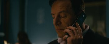 Movie still from “Hotel Mumbai” (2018), directed by Anthony Maras – A person talking on a cell phone; Close Up shot, Low angle