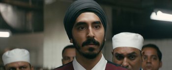 Movie still from “Hotel Mumbai” (2018), directed by Anthony Maras – A person wearing a turban; Close Up shot, Over the shoulder angle