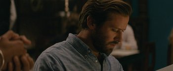 Movie still from “Hotel Mumbai” (2018), directed by Anthony Maras – A person wearing a shirt; Close Up shot, Over the shoulder angle
