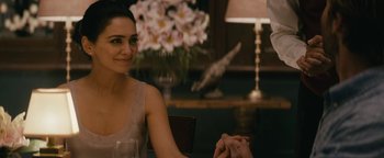 Movie still from “Hotel Mumbai” (2018), directed by Anthony Maras – A woman sitting at a table with a man holding her hand; Close Up shot, Over the shoulder angle