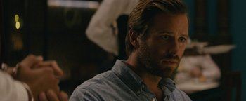 Movie still from “Hotel Mumbai” (2018), directed by Anthony Maras – A person wearing a shirt; Close Up shot, Over the shoulder angle