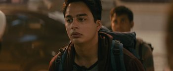 Movie still from “Hotel Mumbai” (2018), directed by Anthony Maras – A young man is looking into the distance; Close Up shot, Low angle