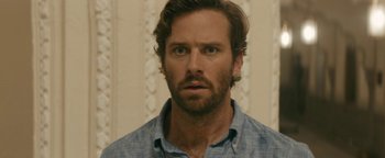 Movie still from “Hotel Mumbai” (2018), directed by Anthony Maras – A person wearing a shirt; Close Up shot, Over the shoulder angle