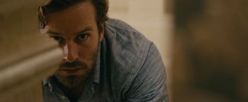 Movie still from “Hotel Mumbai” (2018), directed by Anthony Maras – A person wearing a shirt; Close Up shot, Over the shoulder angle