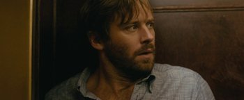 Movie still from “Hotel Mumbai” (2018), directed by Anthony Maras – A person with a beard looking to his left; Close Up shot, Over the shoulder angle