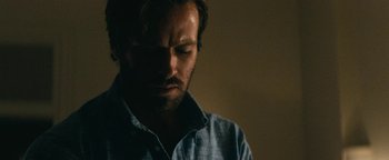 Movie still from “Hotel Mumbai” (2018), directed by Anthony Maras – A person wearing a blue shirt; Close Up shot, Over the shoulder angle