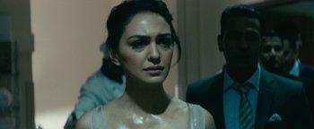 Movie still from “Hotel Mumbai” (2018), directed by Anthony Maras – A person wearing a white shirt; Close Up shot, Over the shoulder angle