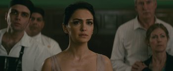 Movie still from “Hotel Mumbai” (2018), directed by Anthony Maras – A person wearing a dress; Close Up shot, Over the shoulder angle