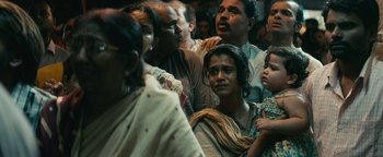 Movie still from “Hotel Mumbai” (2018), directed by Anthony Maras – A group of people standing around each other in a room; Close Up shot, Low angle
