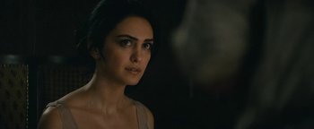 Movie still from “Hotel Mumbai” (2018), directed by Anthony Maras – A beautiful woman with long dark hair looking at the camera; Close Up shot, Over the shoulder angle