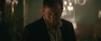 Movie still from “Hotel Mumbai” (2018), directed by Anthony Maras – A person wearing a suit; Close Up shot, Over the shoulder angle