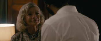 Movie still from “Hotel Mumbai” (2018), directed by Anthony Maras – An older woman and a young man are talking; Close Up shot, Over the shoulder angle