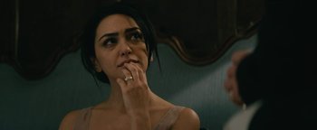 Movie still from “Hotel Mumbai” (2018), directed by Anthony Maras – A woman with a ring on her finger looking at the camera; Close Up shot, Over the shoulder angle