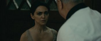 Movie still from “Hotel Mumbai” (2018), directed by Anthony Maras – A woman looking into a mirror while standing next to a man; Close Up shot, Over the shoulder angle