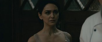 Movie still from “Hotel Mumbai” (2018), directed by Anthony Maras – A person wearing a dress; Close Up shot, Over the shoulder angle