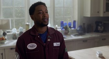 Movie still from “House Party” (2023), directed by Calmatic – A man standing in front of a kitchen counter; Medium shot, Over the shoulder angle