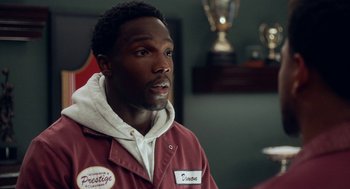 Movie still from “House Party” (2023), directed by Calmatic – A man in a red jacket is looking at the camera; Close Up shot, Over the shoulder angle